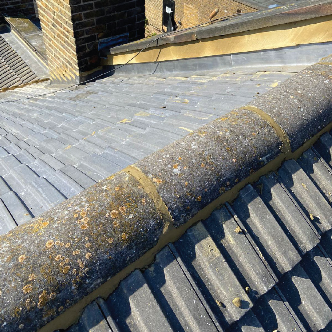 finished grey roof tile repair on sloping house roof