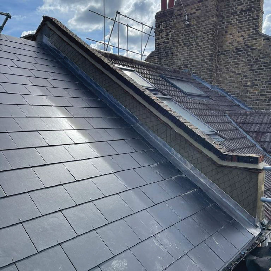 side view of rendering work on wall between roofs