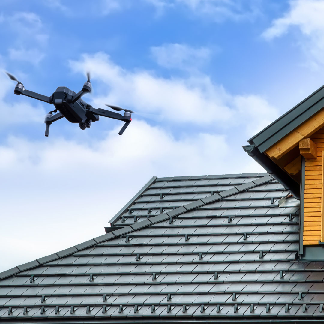 roof survey drone against blue sky with grey roof behind