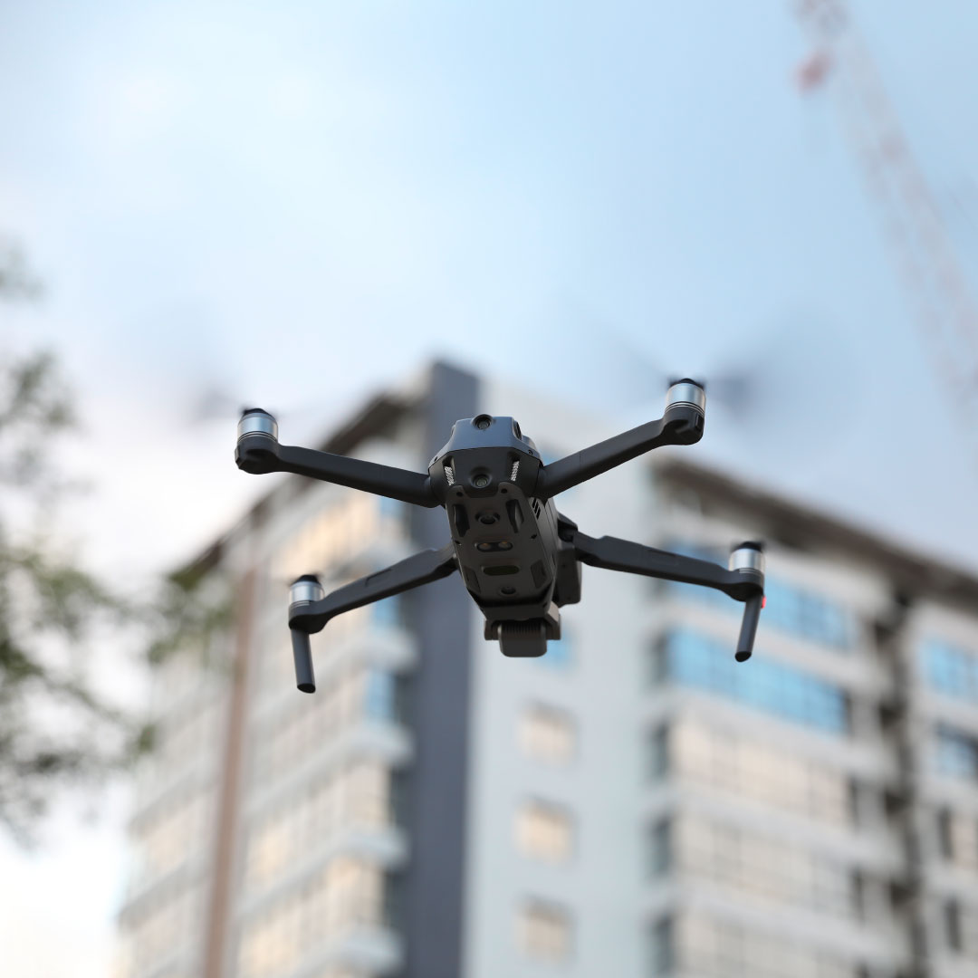 survey drone in focus with large building in background