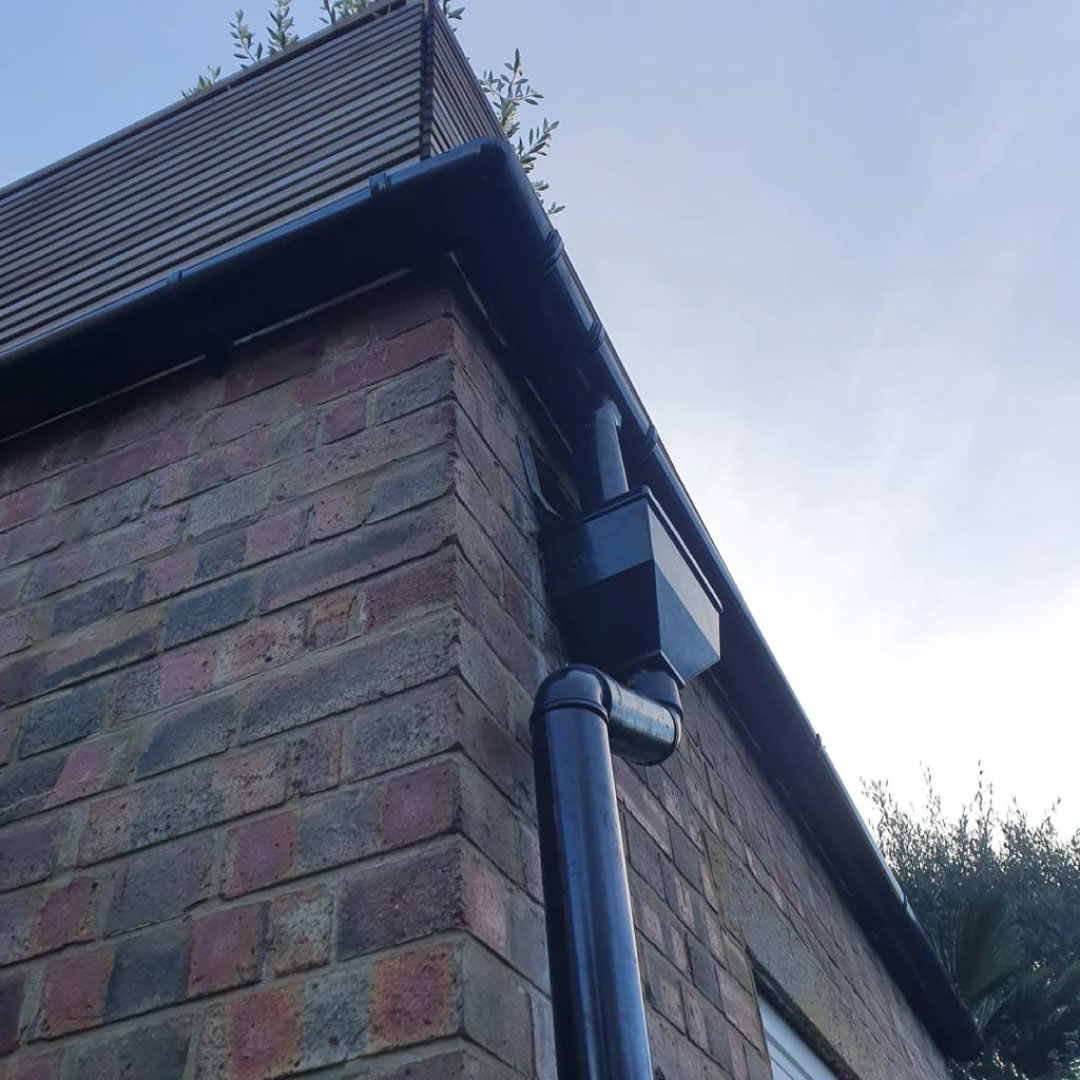 finished gutter replacement and downpipe on house corner
